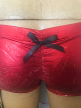 Shiny red and silver booty shorts with garters
